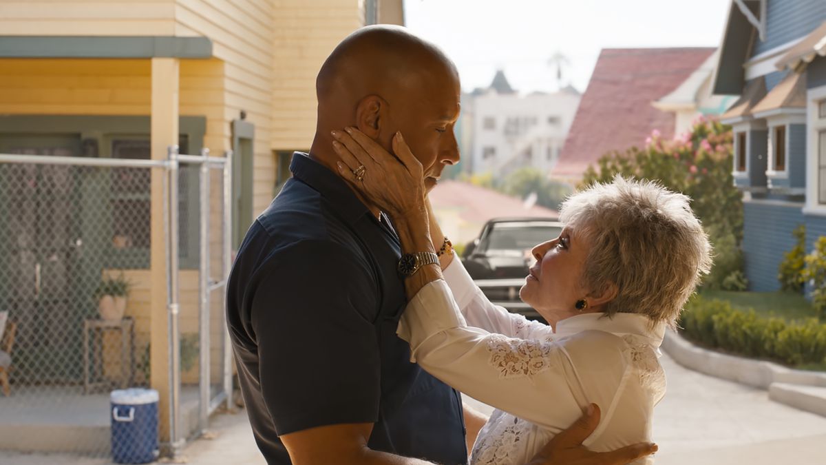 Dom Toretto stands in front of his home while Rita Moreno, playing “Abuelita” holds his face affectionately