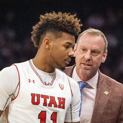 Utah Utes head coach Larry Krystkowiak talks with Utah Utes forward Chris Seeley (11) after he pulls him for committing two quick fouls in the second half as the Runnin' Utes take on the Western Kentucky Hilltoppers in the semifinal round of the 2018 NIT in Madison Square Garden in New York City on Tuesday, March 27, 2018.