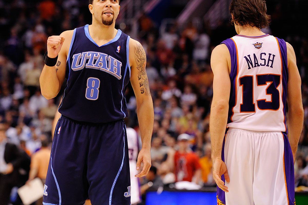 Deron Williams celebrates as a dejected Steve Nash walks off. (Photo by Max Simbron)