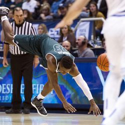 Utah Valley guard Brandon Randolph (23) tumbles to the ground after drawing a foul on a Brigham Young player during an NCAA college basketball game in Provo on Saturday, Nov. 26, 2016. Utah Valley was 18 of 37 from beyond the arc en route to a 114-101 ousting of Brigham Young.