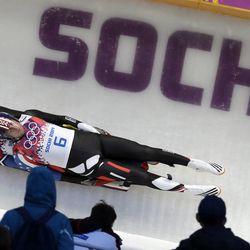 The doubles team of Christian Niccum and Jayson Terdiman of the United States speed down the track on their first run during the men's doubles luge at the 2014 Winter Olympics, Wednesday, Feb. 12, 2014, in Krasnaya Polyana, Russia.