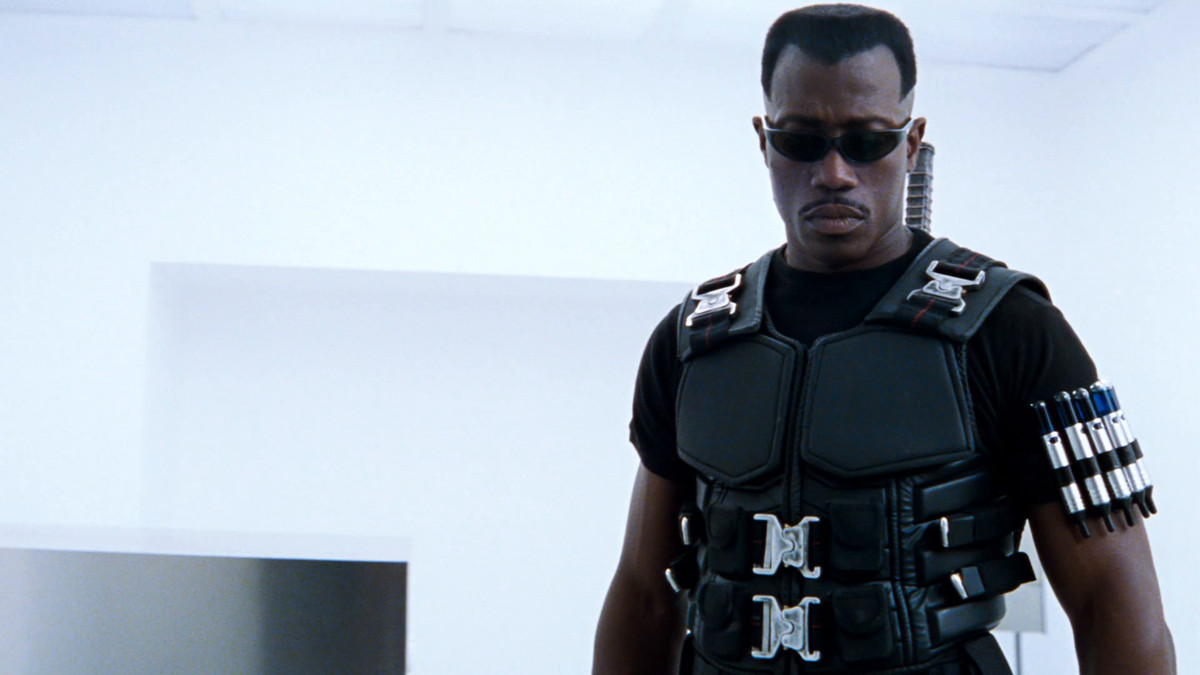 Wesley Snipes as Blade stands in a bright white room from the original Blade (1998) movie