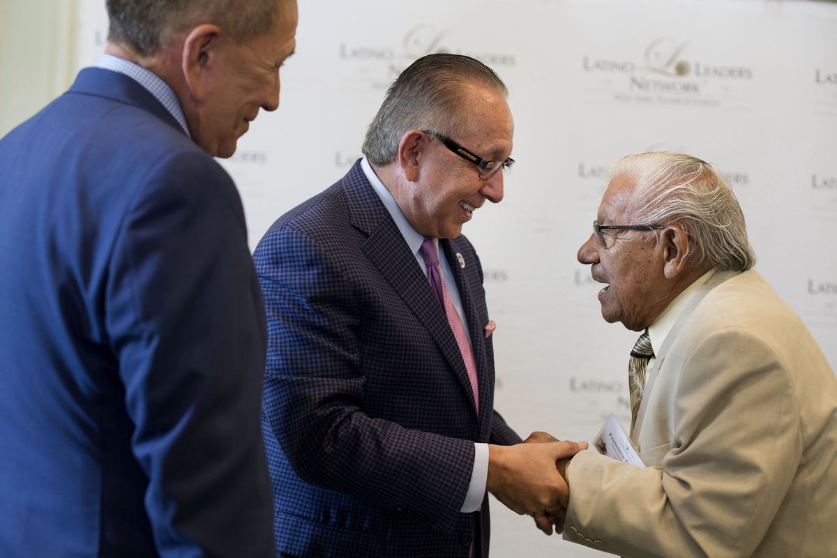 Brothers David and Mickey Ibarra laugh with their father, Francisco, at the 50th Latino Leaders Luncheon Series event at The Grand America Hotel in Salt Lake City on Thursday, July 27, 2017.