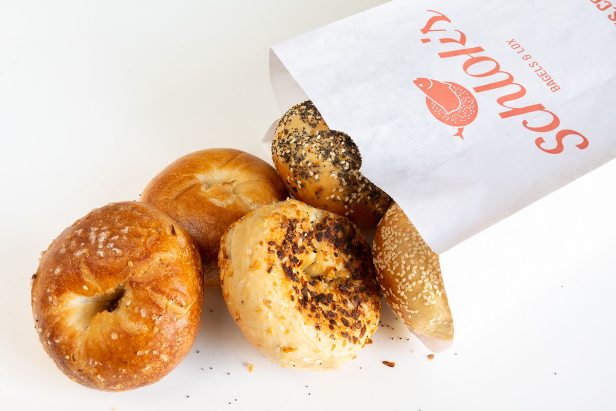 A bag of bagels from Schlok’s spills out onto a table.