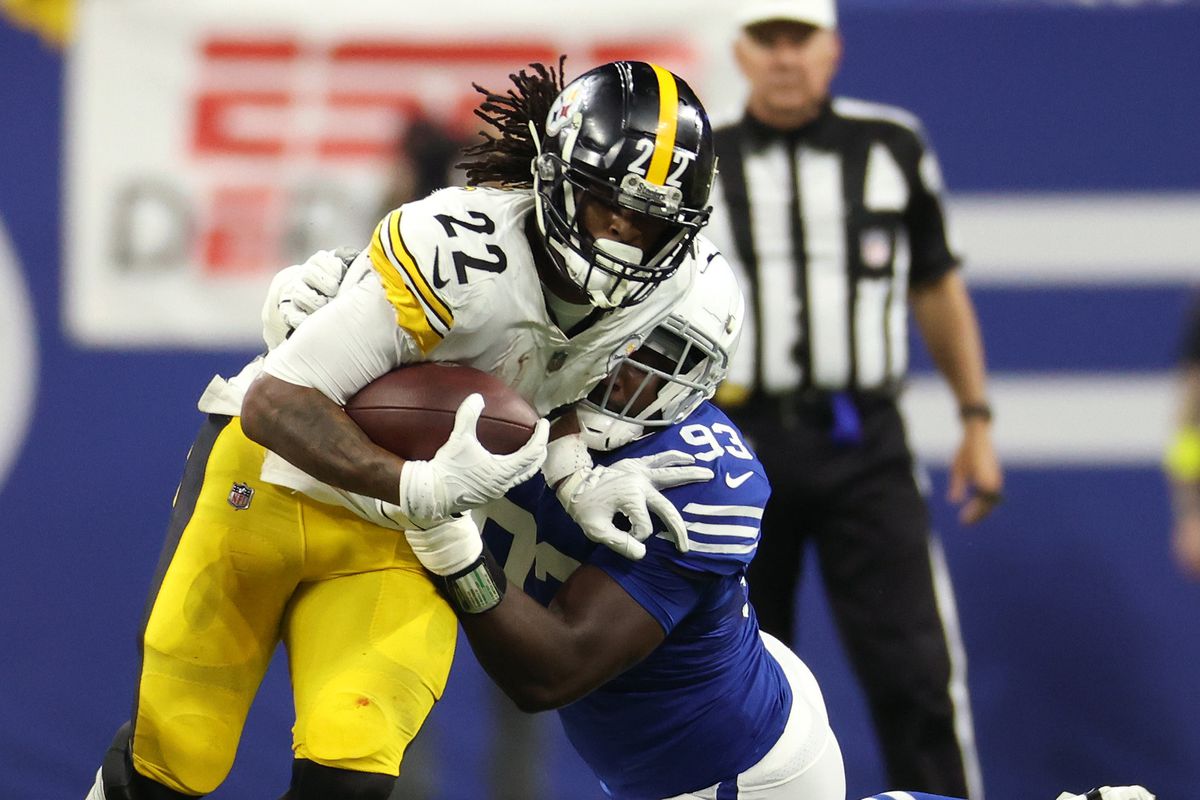 Pittsburgh Steelers running back Najee Harris (22) is tackled by Indianapolis Colts defensive tackle Eric Johnson (93) during the first half at Lucas Oil Stadium.