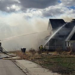 Firefighters battle a Mapleton house fire that caused more than $200,000 in damage on Wednesday, March 9, 2016.