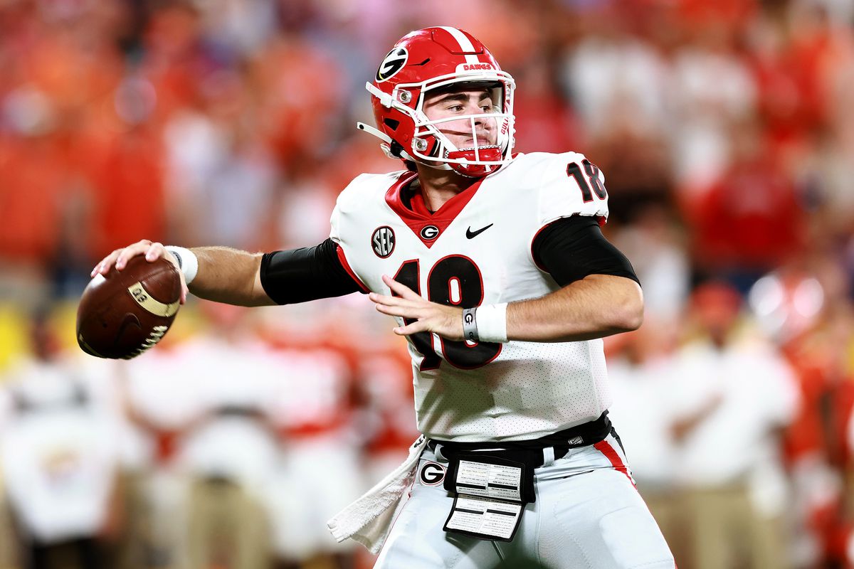 JT Daniels of the Georgia Bulldogs drops back to pass against the Clemson Tigers during the first half of the Duke’s Mayo Classic at Bank of America Stadium on September 04, 2021 in Charlotte, North Carolina.