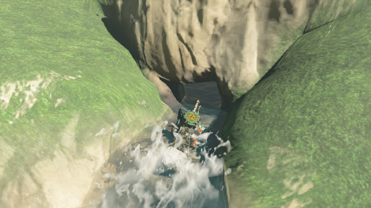 Link crouches in the water in The Legend of Zelda: Tears of the Kingdom. The source of the falls leads to a hidden cave.