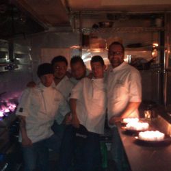 Team Barraca cozied up in the kitchen to make some food by candlelight [Photo: Barraca]