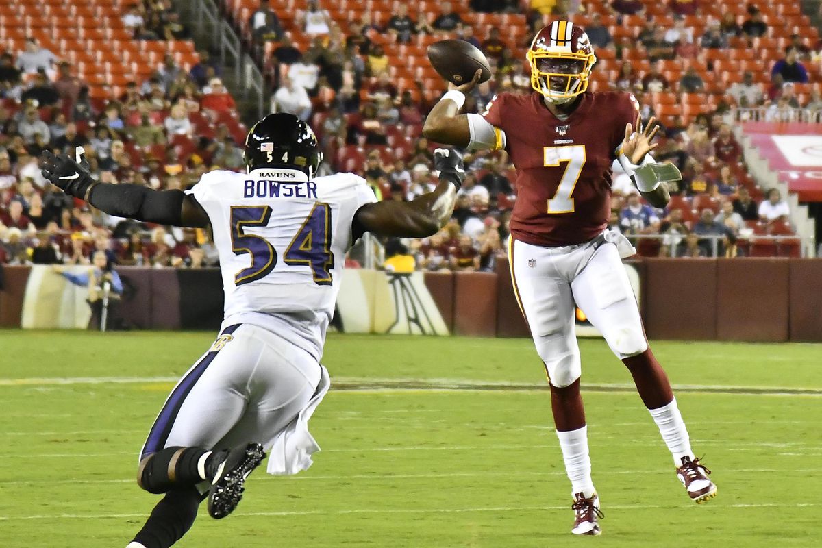 Washington Redskins quarterback Dwayne Haskins throws a touchdown pass over Baltimore Ravens linebacker Tyus Bowser during the first half at FedExField.&nbsp;