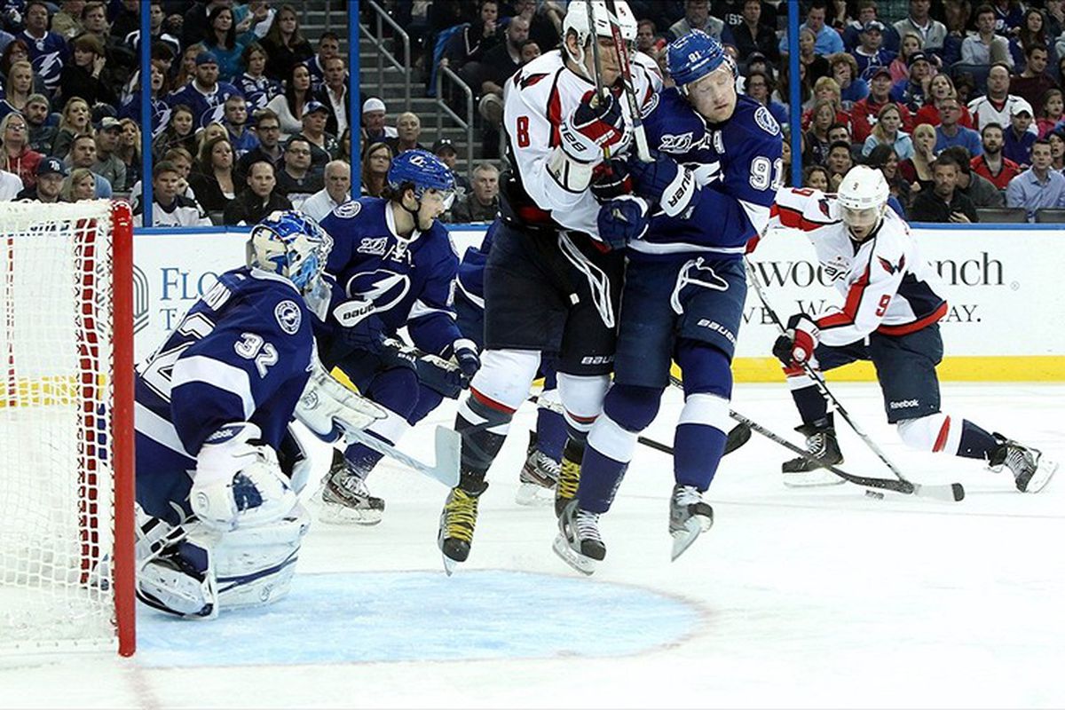 Alex Ovechkin and Steven Stamkos collide in action in front of the Tampa Bay net Thursday night in Tampa.