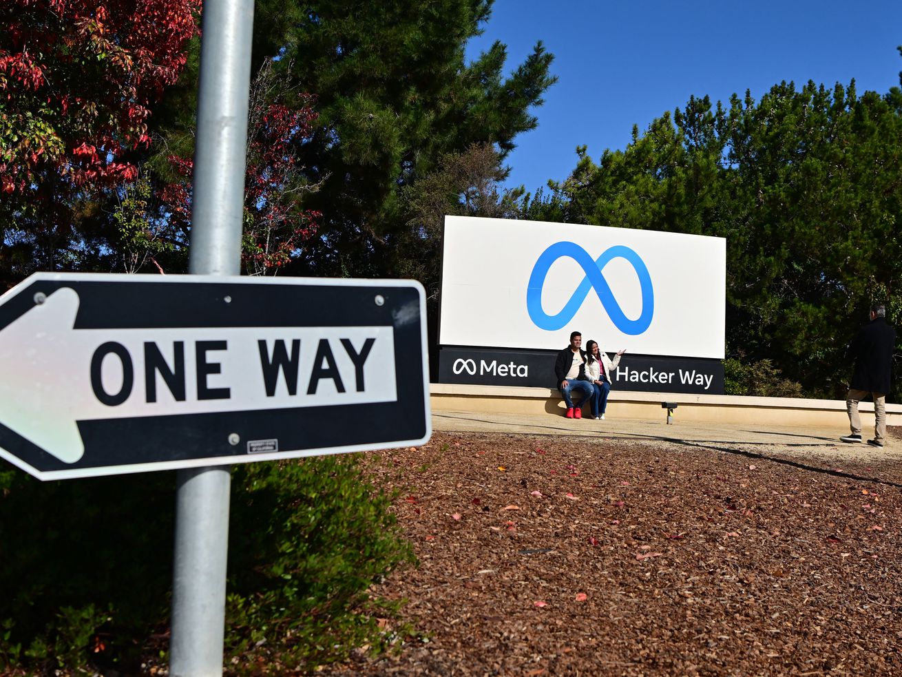 The sign at Meta headquarters, with a one-way traffic sign in the foreground.