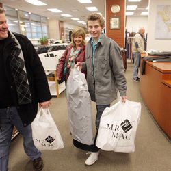 Dallin Barker, along with his parents, Layne and Janine Barker, carries out his newly purchased  LDS missionary clothing from Mr. Mac in Salt Lake City on Tuesday, Jan. 8, 2013.