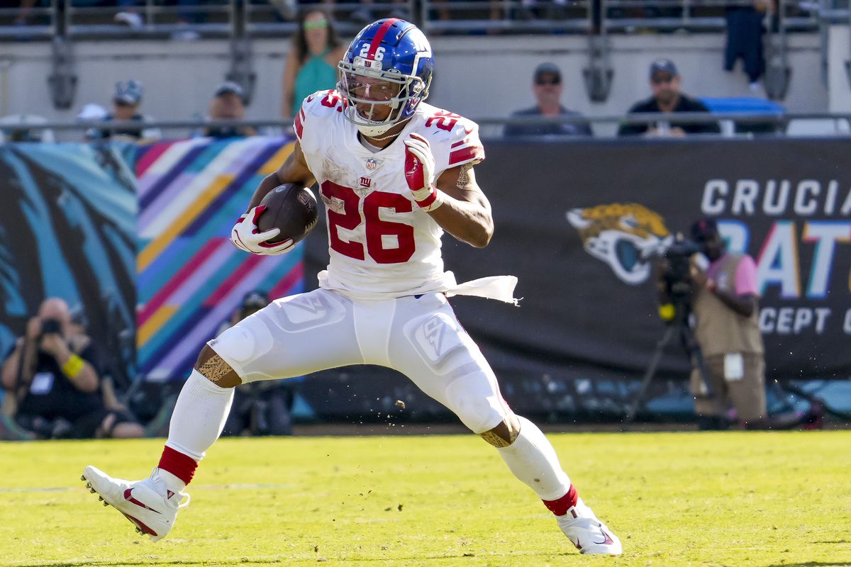 JACKSONVILLE, FL - OCTOBER 23: New York Giants running back Saquon Barkley (26) runs with the ball during the NFL Football match between the Jacksonville Jaguars and New York Giants on October 23, 2022 at TIAA Bank Field, FL.