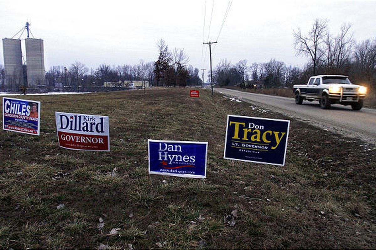 Grain elevators are seen in the background next to an Illinois primary election polling place in Buckhart, Ill., Tuesday.