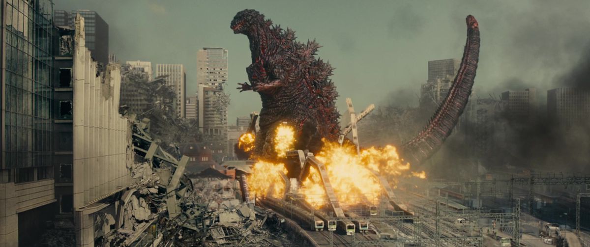 Shin Godzilla stomps on a trainyard and everything explodes