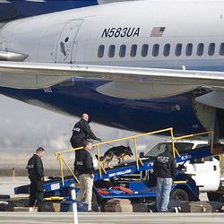 A United Airlines plane is searched and its luggage is removed at Salt Lake City International Airport. The plane, which was on its way from Denver to San Francisco, had a bomb threat written on a note and had to make an emergency landing in Salt Lake City.