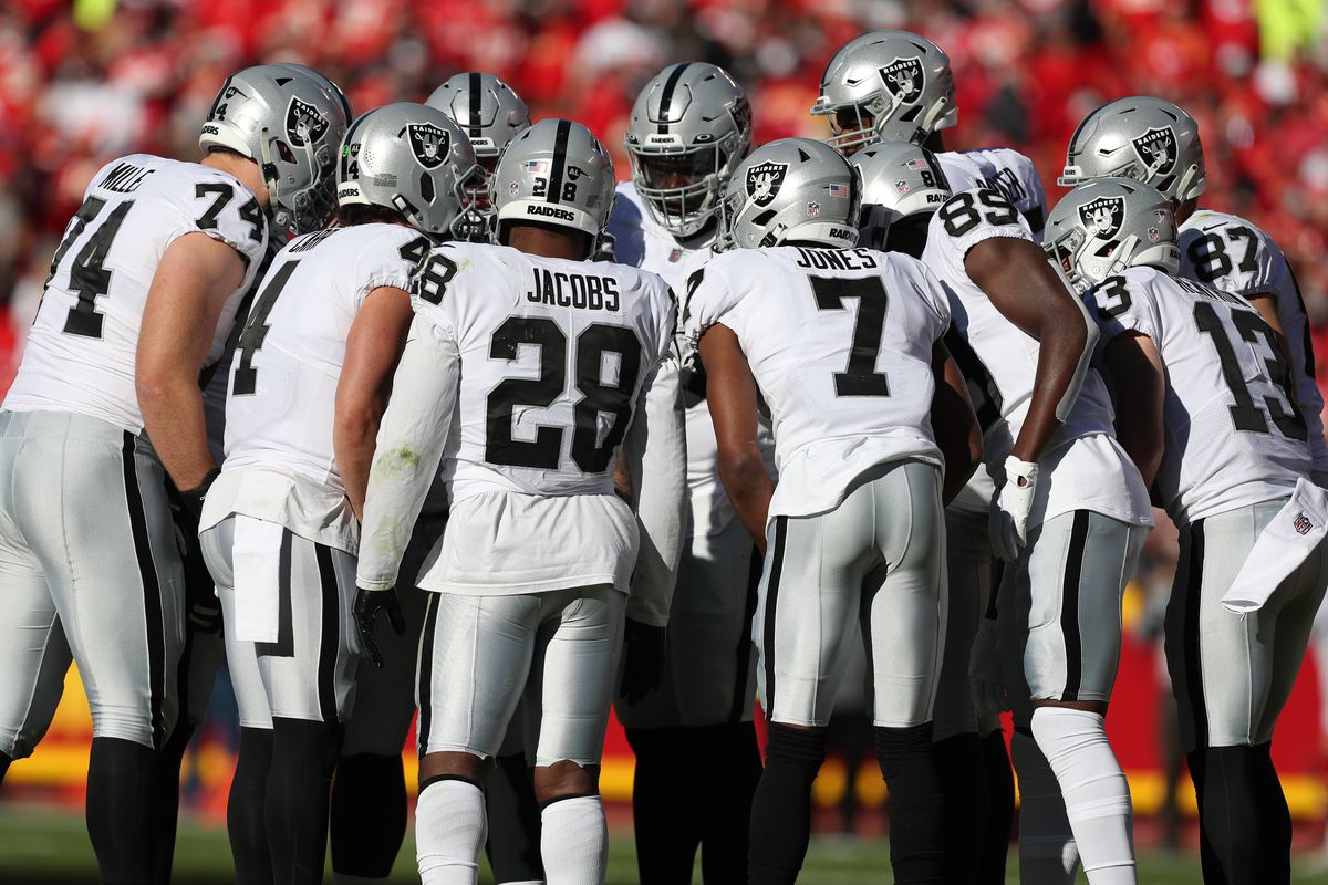 Las Vegas Raiders running back Josh Jacobs (28) and teammates huddle in the second quarter of an NFL game between the Las Vegas Raiders and Kansas City Chiefs on Dec 12, 2021 at GEHA Field at Arrowhead Stadium in Kansas City, MO.