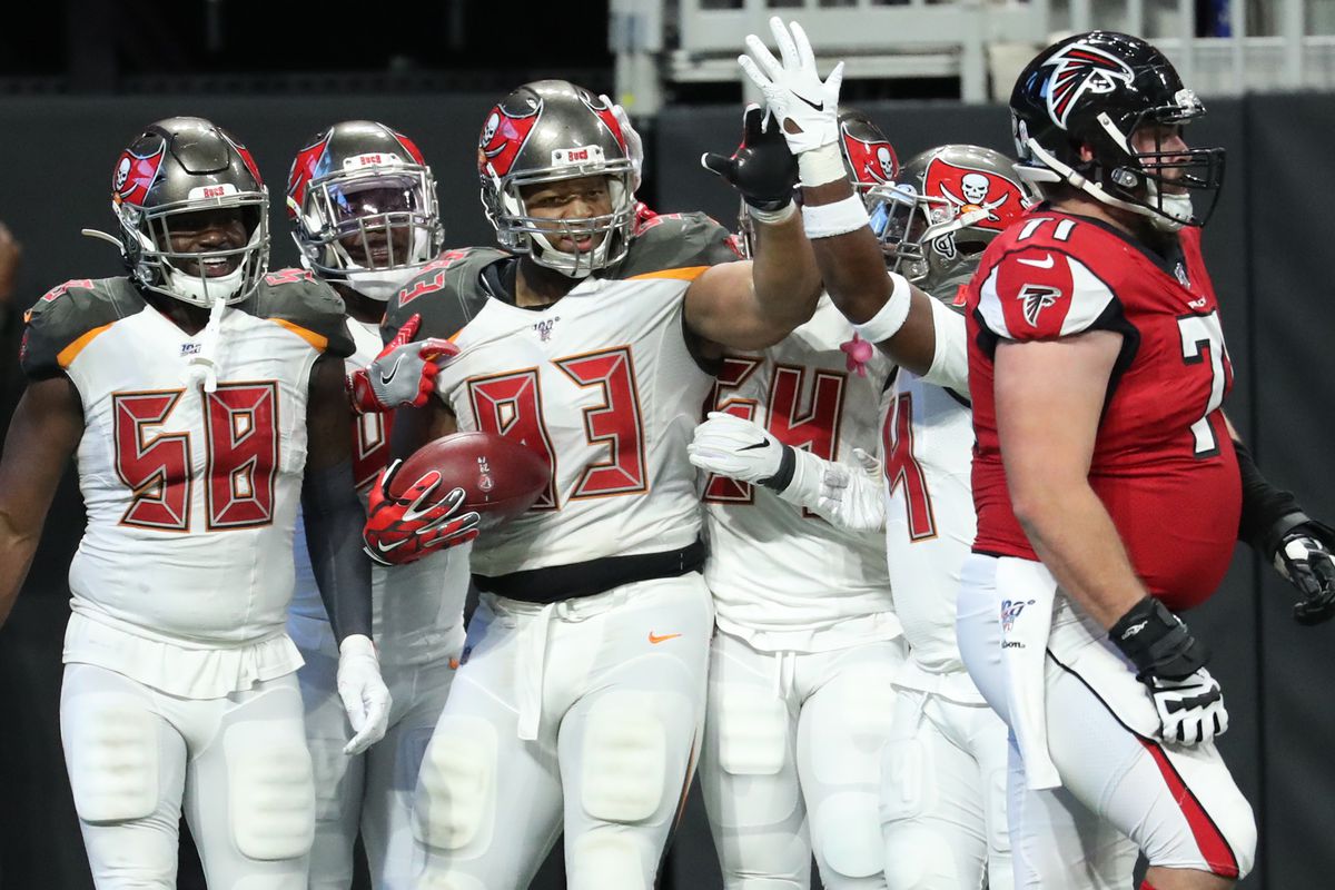 Tampa Bay Buccaneers nose tackle Ndamukong Suh celebrates his fumble returned for a touchdown with safety Mike Edwards and linebacker Shaquil Barrett as Atlanta Falcons offensive guard Wes Schweitzer walks off of the field in the fourth quarter.