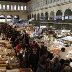 Shoppers fill the central fish market ahead of the Christian Orthodox lent fast, in Athens, on Friday, Feb. 20, 2015. Greece and its European creditors are converging on Brussels to try to bridge major differences over Athens' request for a six-month loan extension to help pay off massive debts. The meeting on Friday is the third among finance ministers from the 19-nation eurozone in just over a week. 