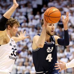 Brigham Young Cougars forward Caleb Lohner (33) defends Utah State Aggies forward Brandon Horvath (4) as BYU and Utah State play an NCAA basketball game in Provo at the Marriott Center on Wednesday, Dec. 8, 2021.