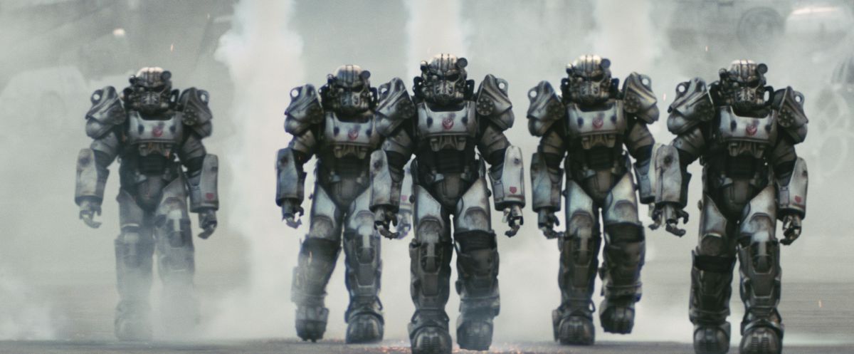 A line of Brotherhood of Steel soldiers in power armor walking forward in the Fallout TV series