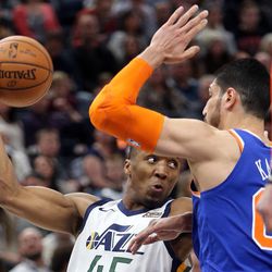 Utah Jazz guard Donovan Mitchell (45) passes the ball around New York Knicks center Enes Kanter (00) during a basketball game at the Vivint Smart Home Arena in Salt Lake City on Friday, Jan. 19, 2018.