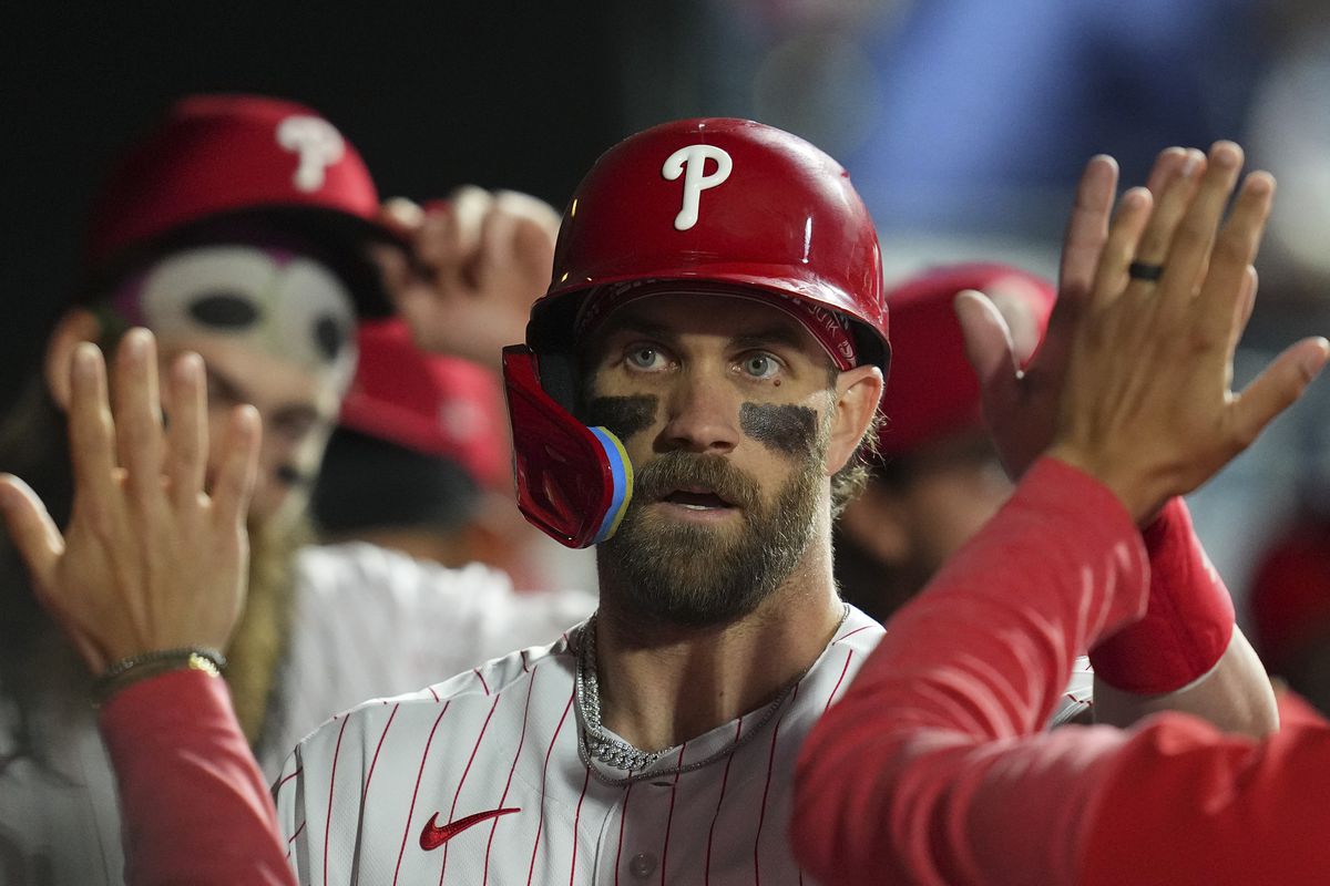 Bryce Harper of the Philadelphia Phillies high fives his teammates against the Boston Red Sox at Citizens Bank Park on May 5, 2023 in Philadelphia, Pennsylvania.