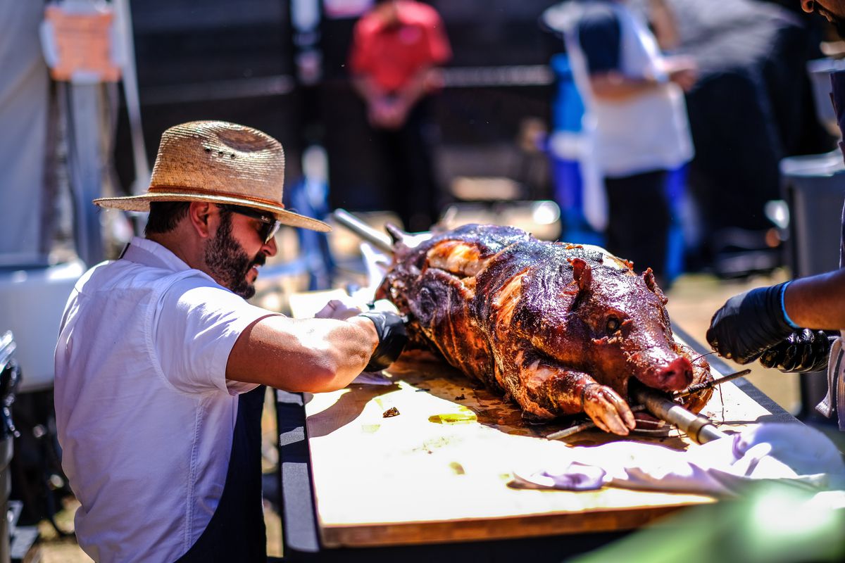 Taking the pig off the spit at the fire pits at Austin Food &amp; Wine Festival 2019