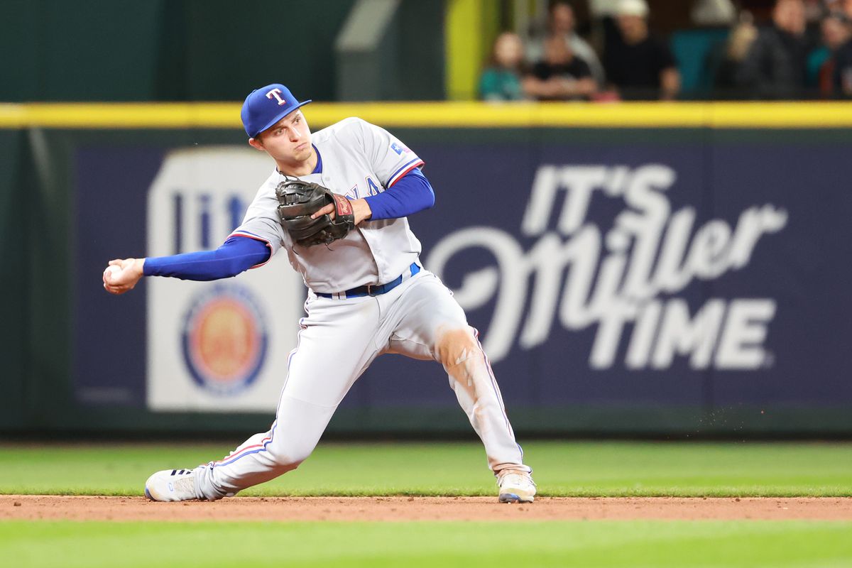 Corey Seager #5 of the Texas Rangers throws to second base to force an out during the eighth inning against the Seattle Mariners at T-Mobile Park on April 19, 2022 in Seattle, Washington.