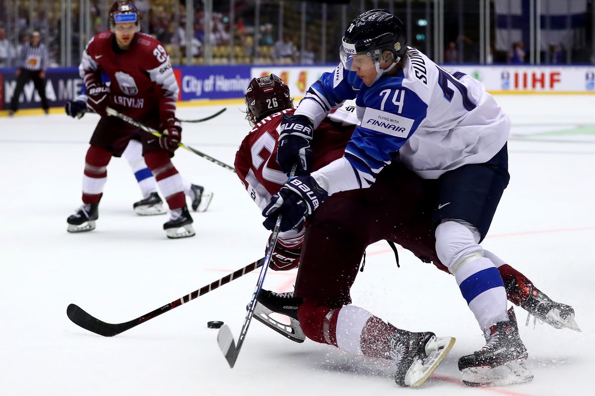 HERNING, DENMARK - MAY 06: Uvis Balinskis (L) of Latvia and Antti Suomela of Finland battle for the puck during the 2018 IIHF Ice Hockey World Championship group stage game between Latvia and Finland at Jyske Bank Boxen on May 6, 2018 in Herning, Denmark.