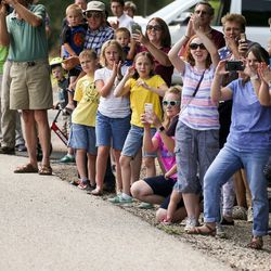 Spectators cheer as Stage 5 of the Tour of Utah rides down U.S. 89 from Layton to Bountiful on Friday, Aug. 4, 2017.