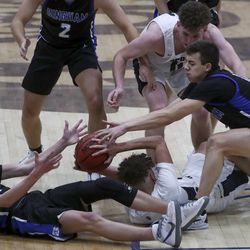 Players battle for a loose ball during the Bingham at Copper Hills boys basketball game in West Jordan on Tuesday, Feb. 2, 2021.