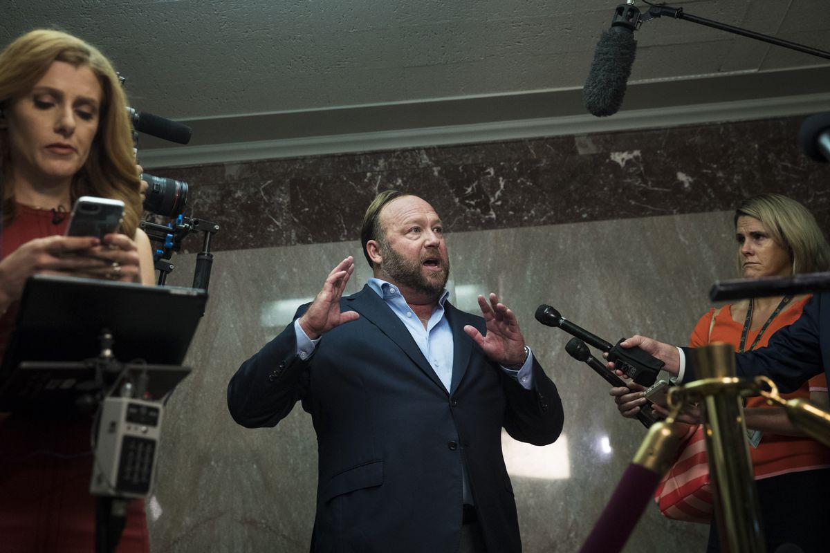 InfoWars founder Alex Jones speaking to reporters outside a hearing room on Capitol Hill.