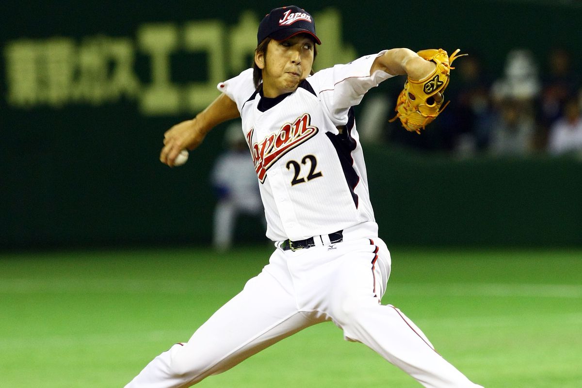 Kyuji Fujikawa of Japan throws a pitch during the World Baseball Classic Pool A match between Japan and South Korea at Tokyo Dome.