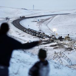 Law enforcement vehicles line a road leading to a blocked bridge next to the Oceti Sakowin camp where people have gathered to protest the Dakota Access oil pipeline in Cannon Ball, N.D., Saturday, Dec. 3, 2016. 