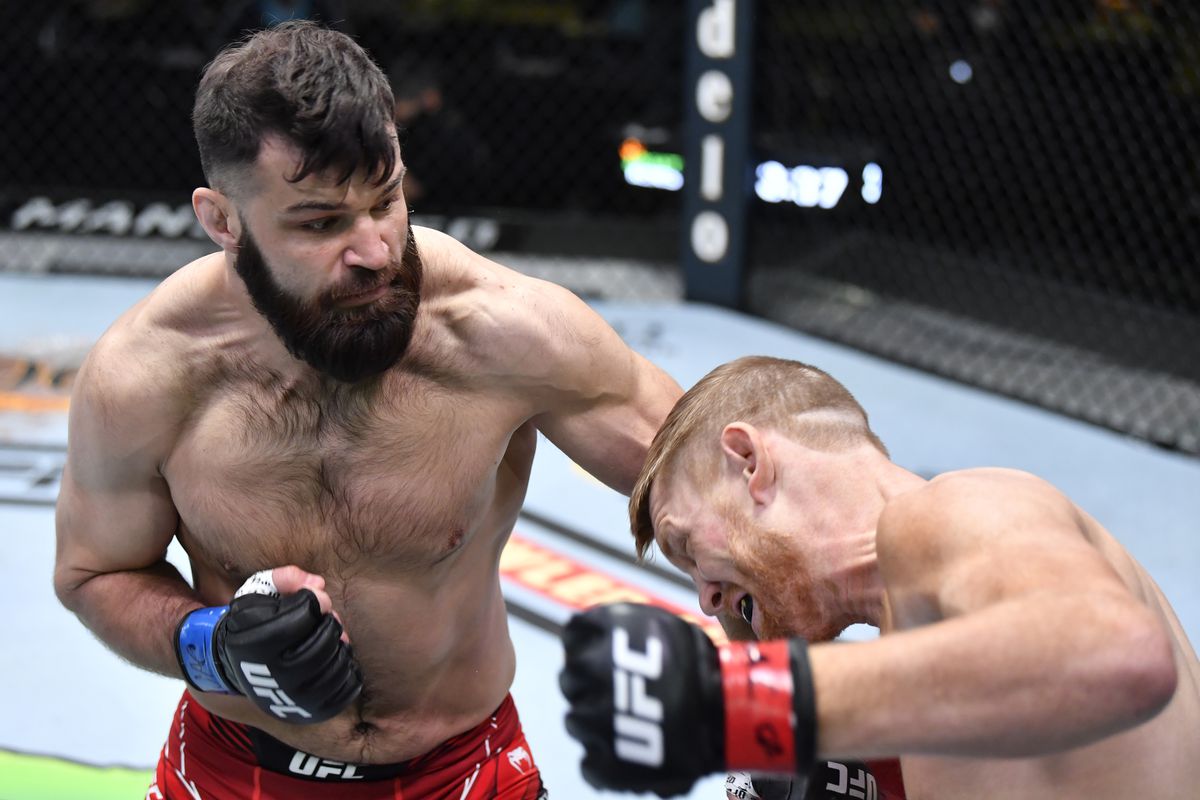 In this handout image provided by UFC, (L-R) Julian Marquez punches Sam Alvey in a middleweight fight during the UFC Fight Night event at UFC APEX