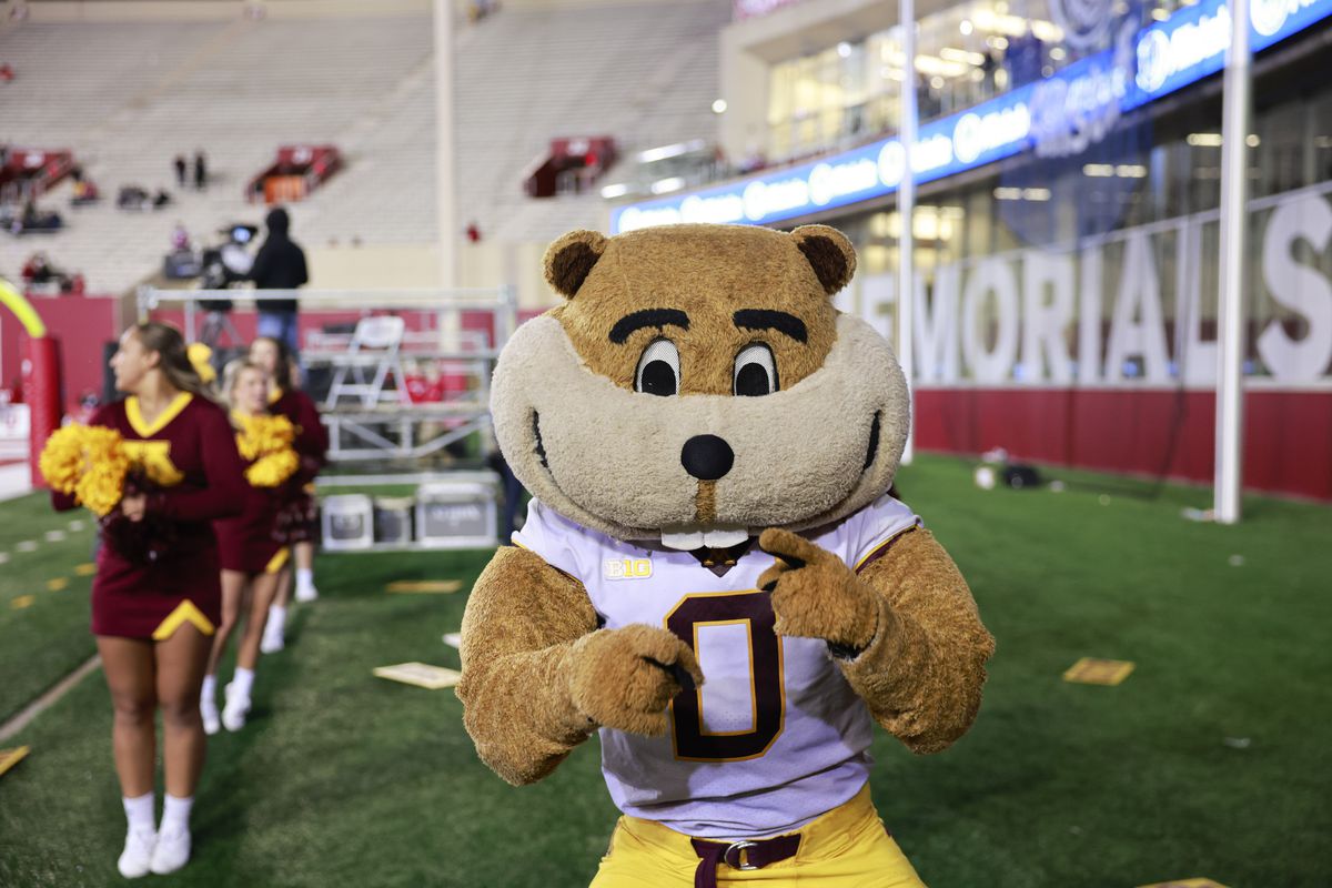 Minnesotas cheerleaders and mascot, Goldy, cheer against...
