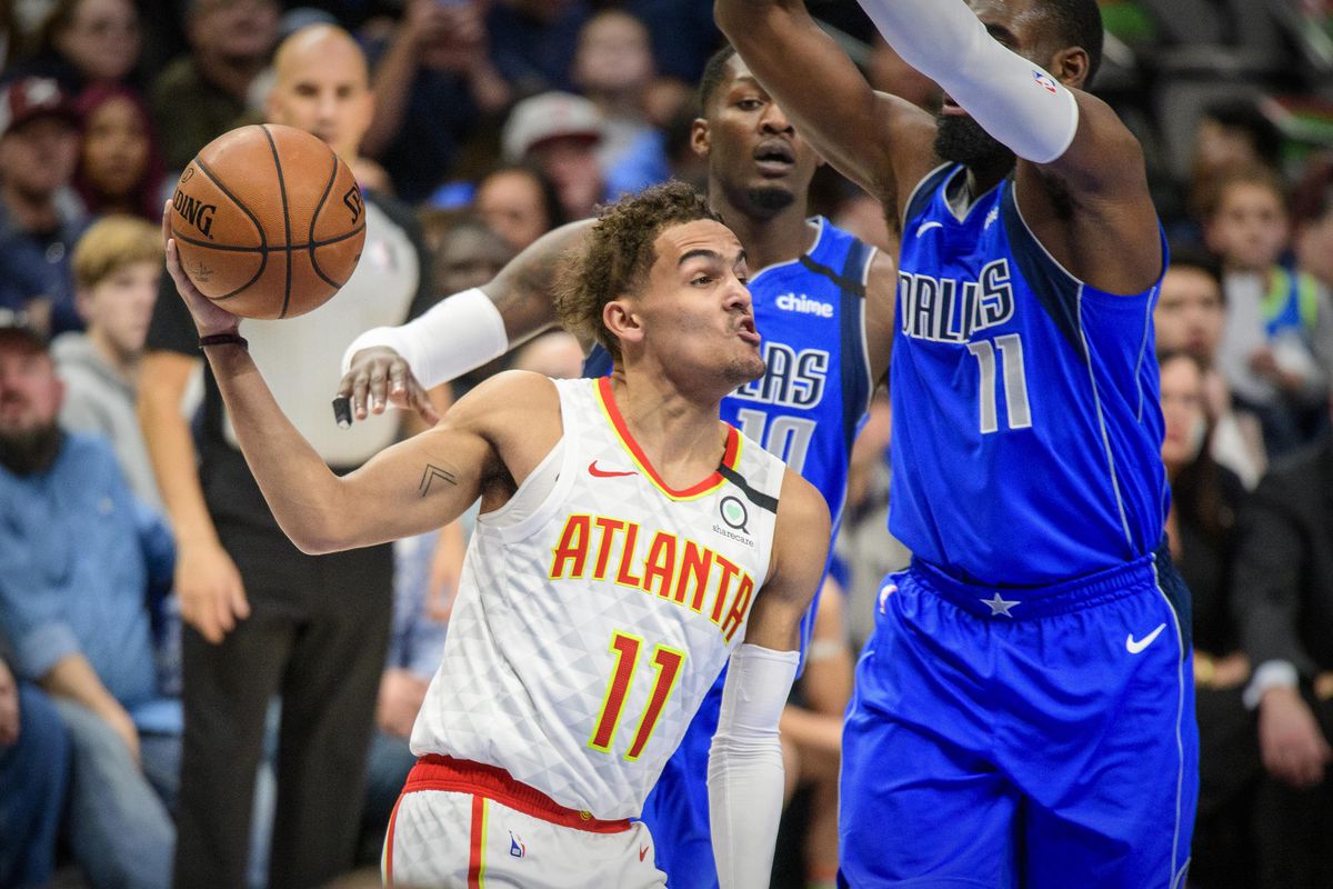 Atlanta Hawks guard Trae Young passes the ball around Dallas Mavericks guard Tim Hardaway Jr. during the first quarter at the American Airlines Center.&nbsp;