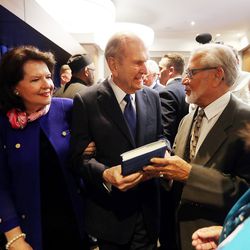 President Russell M. Nelson is handed a book from author Victor Begg as he and his wife, Sister Wendy Nelson, meet VIPs prior to a devotional at the Amway Center in Orlando, Florida, on Sunday, June 9, 2019.