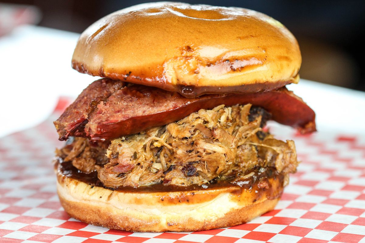 Pecos Pit BBQ brings items like this pork sandwich topped with a hot link to CenturyLink Field.