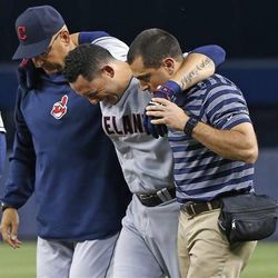 Cleveland Indians' Asdrubal Cabrera is helped by Indians manager Terry Francona, left, and a trainer as he leaves the field in the fifth inning after Cabrera strained his right quadriceps in a baseball game against the New York Yankees at Yankee Stadium in New York, Monday, June 3, 2013.