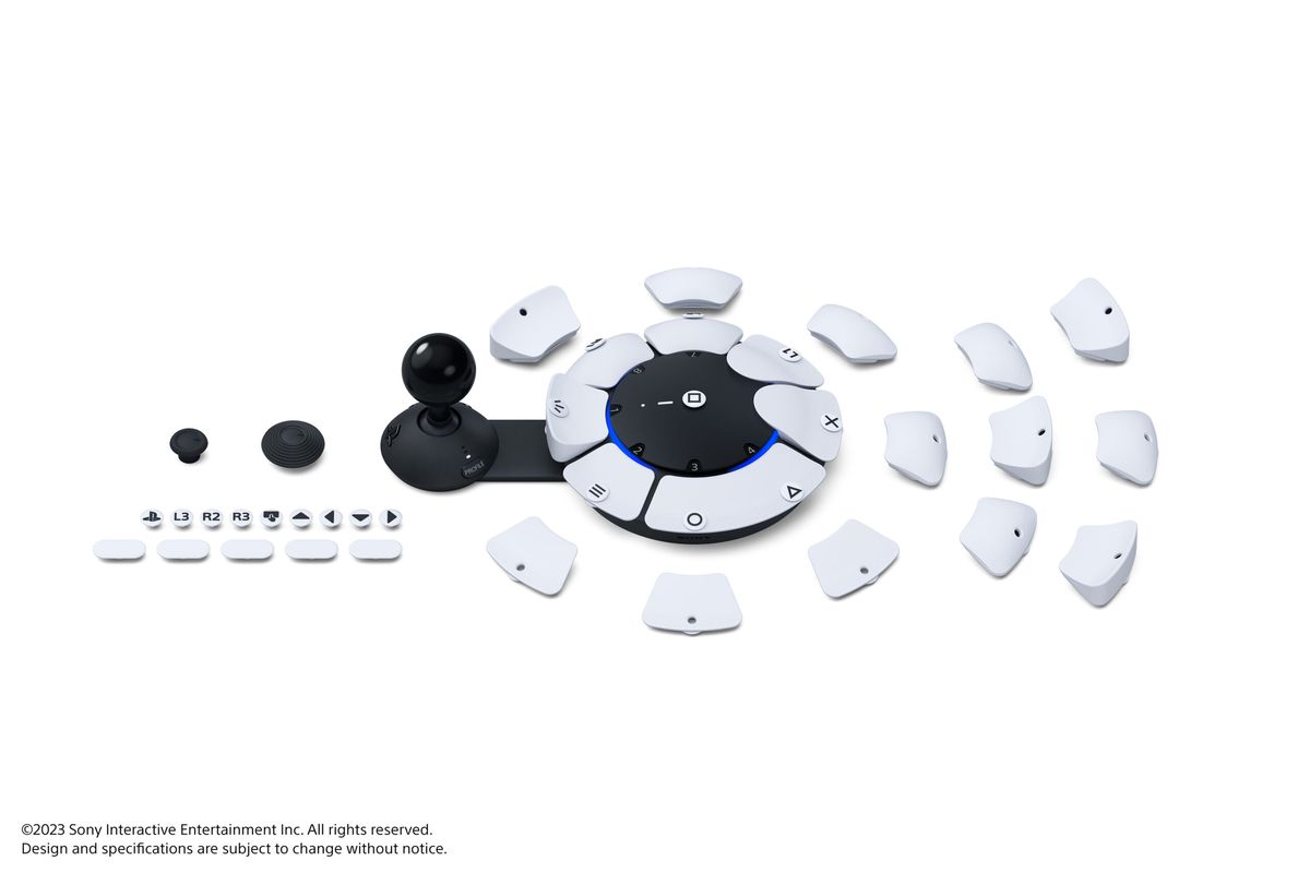 A product photo of the Access controller, a white circular device with a bunch of interchangeable buttons.