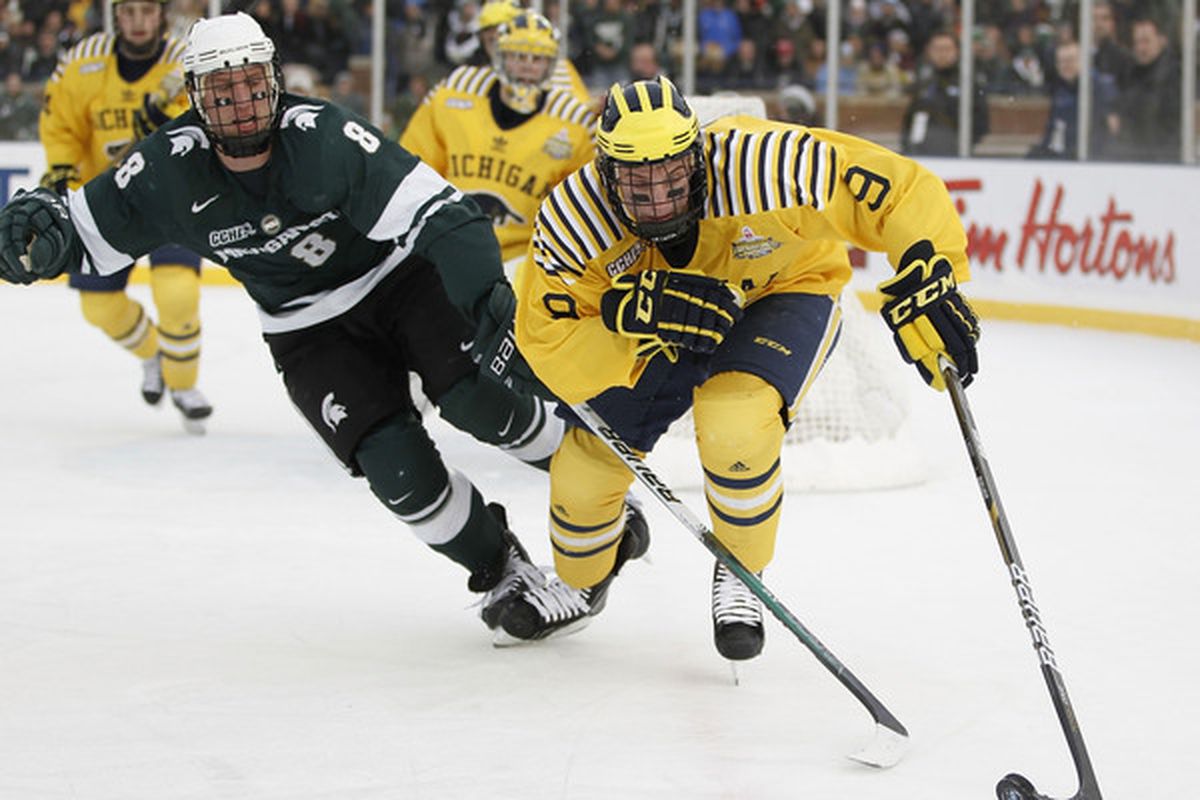 ANN ARBOR MI - DECEMBER 11:  Luke Moffatt #9 of the Michigan Wolverines battles for the puck with Chris Forfar #8 of the Michigan State Spartans at Michigan Stadium on December 11 2010 in Ann Arbor Michigan.  (Photo by Gregory Shamus/Getty Images)