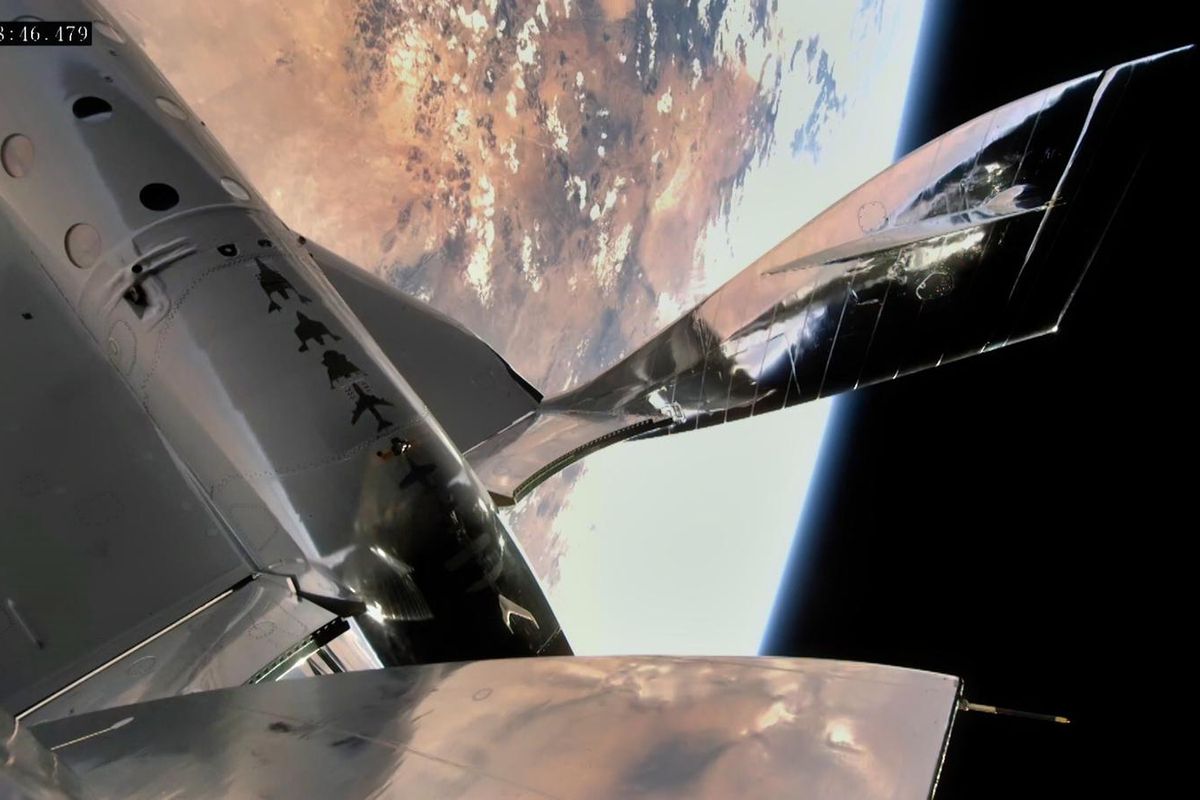 The wing of an orbiting spaceship with Earth and black space behind it.