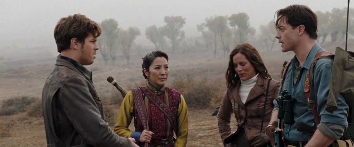 Ancient sorceress Zi Yuan (Michelle Yeoh) stands in a misty field with adventurer couple Evelyn (Maria Bello) and Rick (Brendan Fraser) in The Mummy: Tomb of the Dragon Emperor, the only movie Oscars 2023 Best Actor and Actress frontrunners Fraser and Yeoh made together