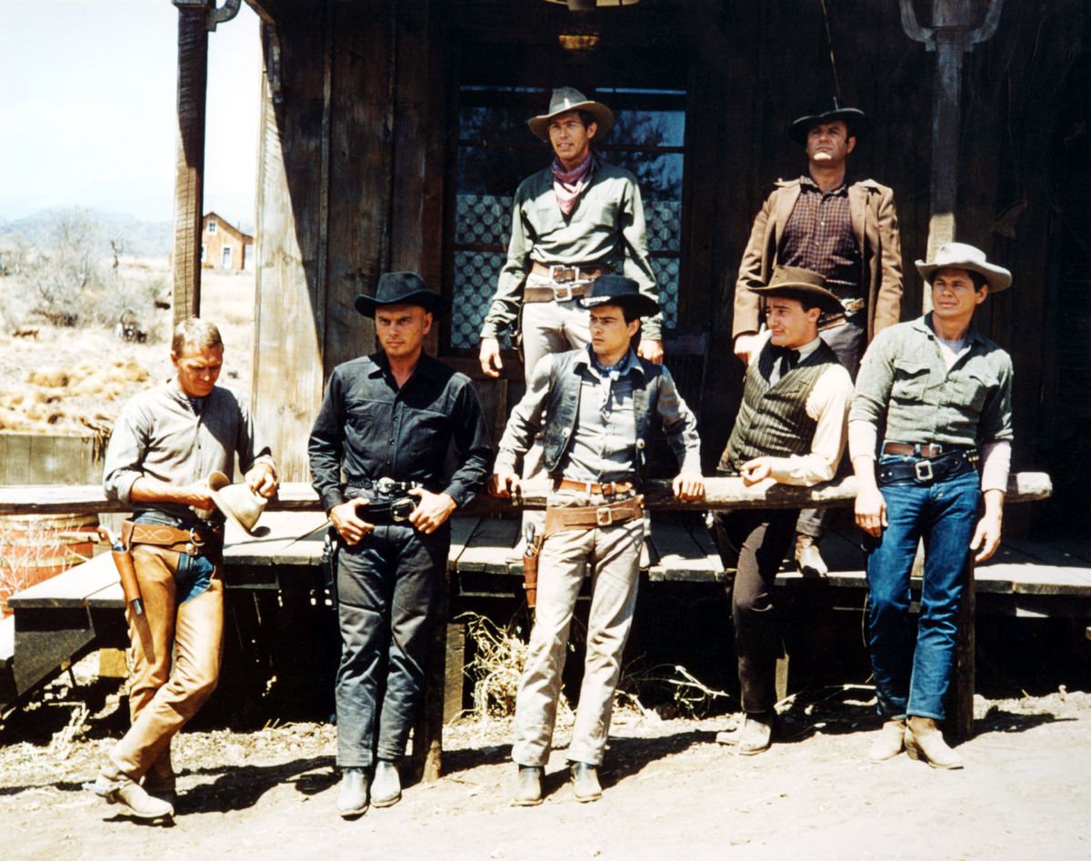 The seven cowboys in The Magnificent Seven stand around each other in the sun