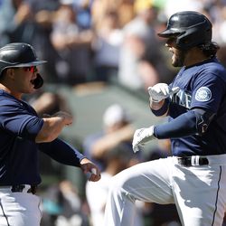 SEATTLE, WASHINGTON - SEPTEMBER 07: Eugenio Suarez #28 of the Seattle Mariners reacts after his two-run home run with Ty France #23 for his 1000th career hit during the third inning against the Chicago White Sox at T-Mobile Park on September 07, 2022 in Seattle, Washington