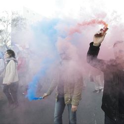 Anti-gay marriage activists hold smoke flares with the color of the logo of the movement during a rally to protest the new law after French lawmakers legalized same-sex marriage, Tuesday, April 23, 2013, in Paris. Lawmakers legalized same-sex marriage after months of debate and street protests that brought many thousands to protest in Paris. Tuesday's 331-225 vote came in the Socialist majority National Assembly and France's justice minister, Christiane Taubira, said the first weddings could be as soon as June. (AP Photo/Michel Euler)  