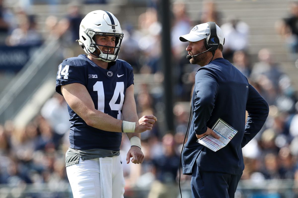 Penn State Nittany Lions offensive coordinator Mike Yurcich talks with quarterback Sean Clifford (14) during the Blue White spring game at Beaver Stadium. The defense defeated the offense 17-13.